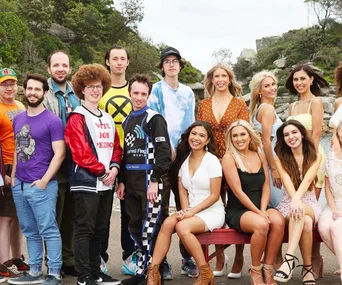 Cast of Beauty and the Geek 2021 group photo outdoors, with trees in the background.