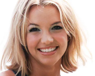 Close-up of a young woman with blonde hair smiling against a plain white background.