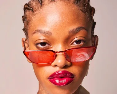 Model with red sunglasses and glossy lips at Paris Fashion Week Spring/Summer 2022.