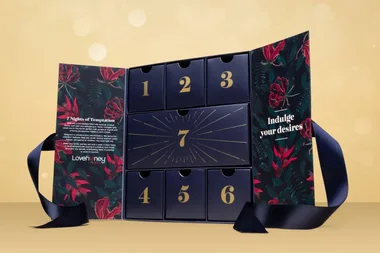 Lovehoney advent calendar with floral design, numbered drawers, and text "Indulge your desires" on side panel.