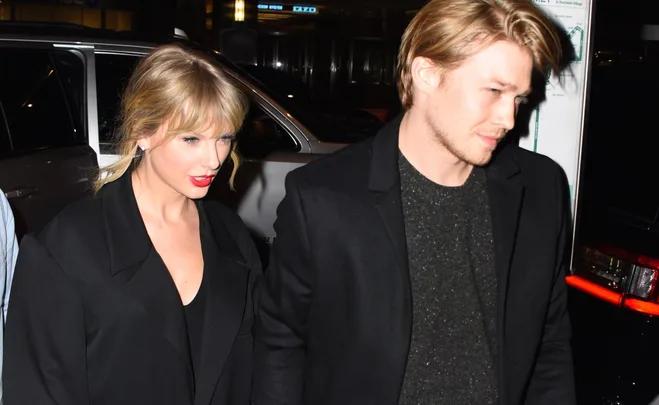 A couple walking together at night, both wearing dark jackets, visible in a close-up shot.