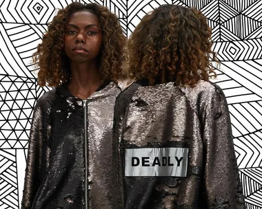 Model wearing a sequin jacket with "DEADLY" on the back, against a geometric patterned background.