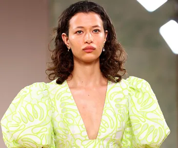 Model in a neon print dress with puffed sleeves at Aje Resort 23 show.