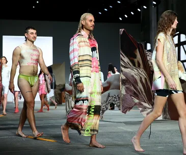 Models walking the runway in vibrant, patterned outfits at Australian Fashion Week.