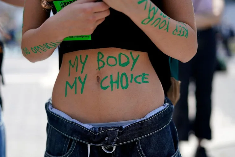 Protester with "My Body My Choice" written on stomach at an abortion rights demonstration.