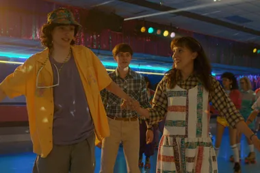 Characters roller skating at a vibrant, colorful rink in “Stranger Things” season four.