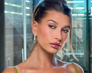 Hailey Bieber Continues Her Dessert-Inspired Reign By Sharing Her Go-To Lip Combo, ‘Glazed Brownie Lips’