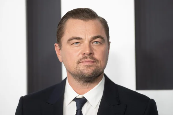 A man in a suit and tie at a formal event, facing the camera, with a neutral expression.