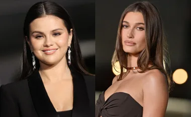 Two women standing side by side, dressed in evening wear, with long hair and neutral expressions.