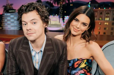 Kendall Jenner and Harry Styles smiling together on a talk show set.