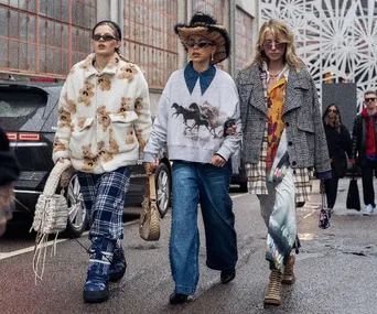 Three women in eclectic streetwear walk confidently during Copenhagen Fashion Week FW23.