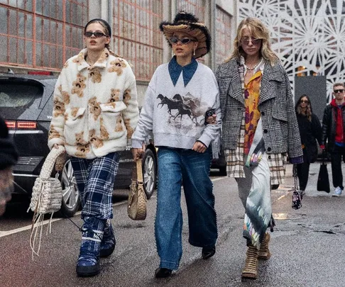 Three women in eclectic streetwear walk confidently during Copenhagen Fashion Week FW23.
