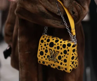 Yellow Louis Vuitton bag with black polka dots from the Yayoi Kusama collaboration.