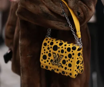 Yellow Louis Vuitton bag with black polka dots from the Yayoi Kusama collaboration.