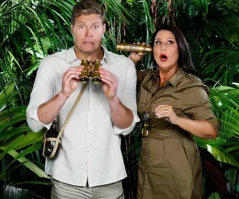 Two hosts in jungle-themed outfits react humorously, one holding binoculars and the other a brass telescope.