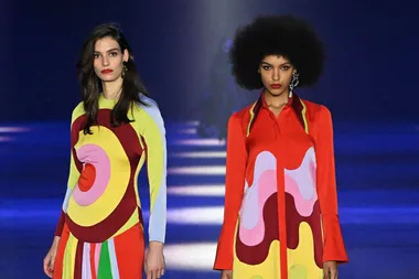 Models in colorful outfits on the runway at Afterpay Australian Fashion Week 2023.