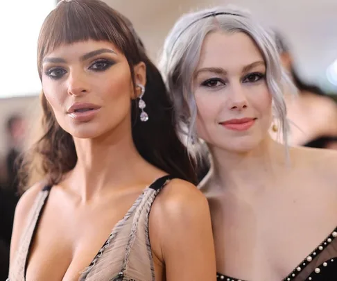 Two women pose together at the Met Gala 2023, both in elegant attire with distinctive hairstyles and makeup.