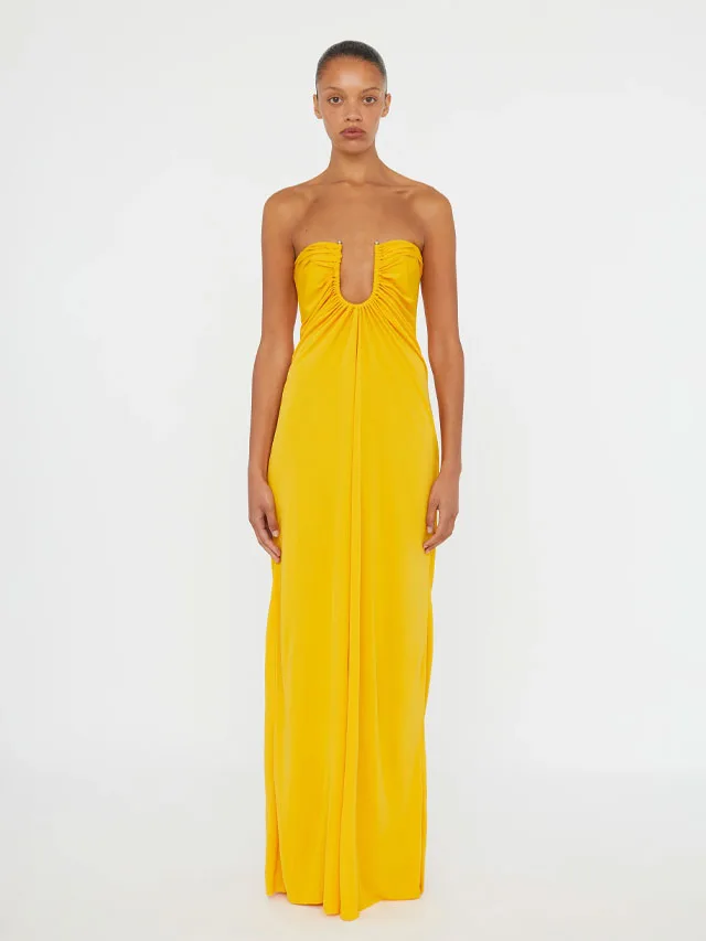 Model wearing a saffron coloured maxi dress