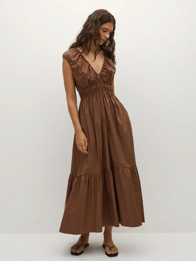 Model wearing a brown maxi length dress