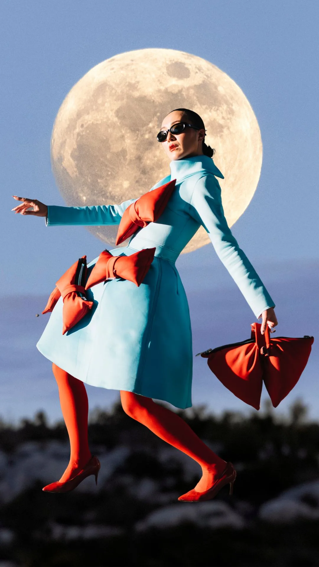 woman dancing in front of a moon 