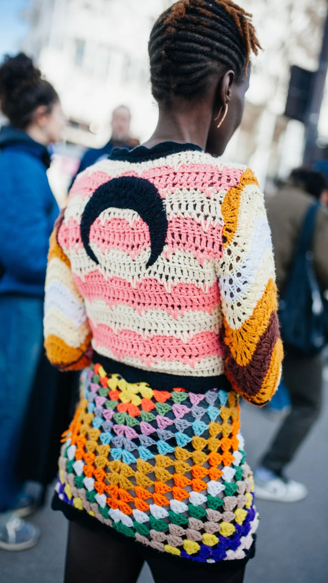 Girl wearing crochet jumper with half moon on it 