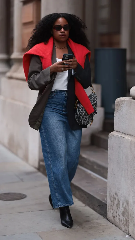 woman wearing red sweater around shoulders