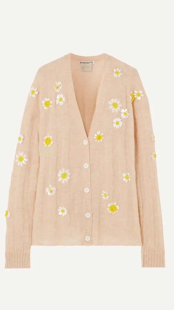 This feminine take on the grandpa cardigan from Bernadette features a  beige pink alpaca blend with embellished daisy appliques. 