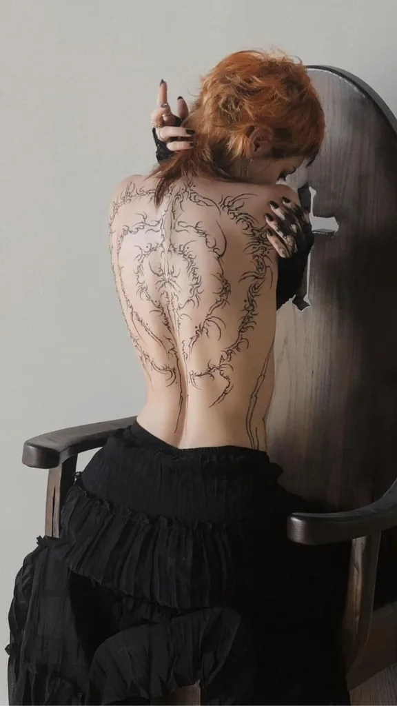 woman with cybersigilism tattoo on her back