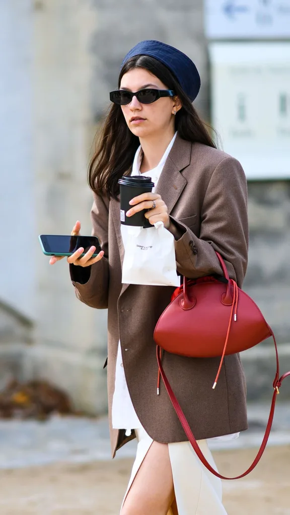 stylish woman with tiger nut milk coffee and red bag