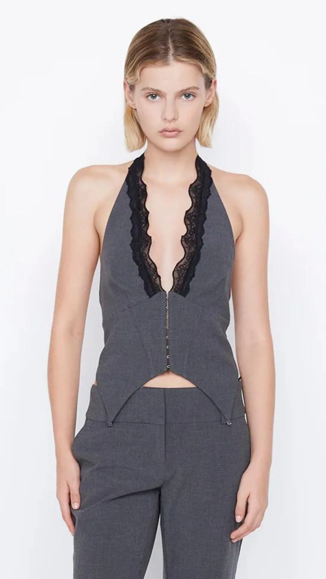 We love the lingerie-inspired finishes on the Naida Bec+Bridge suit-style halter top with lace details on the plunging neckline and corset-inspired front hook-and-eye closures.