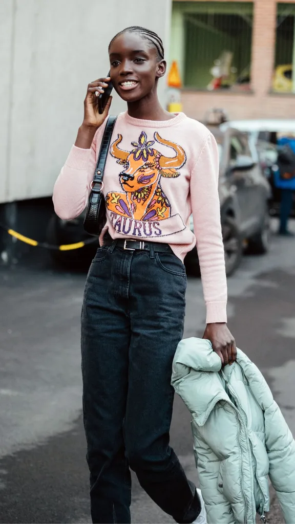 woman wearing taurus star sign jumper