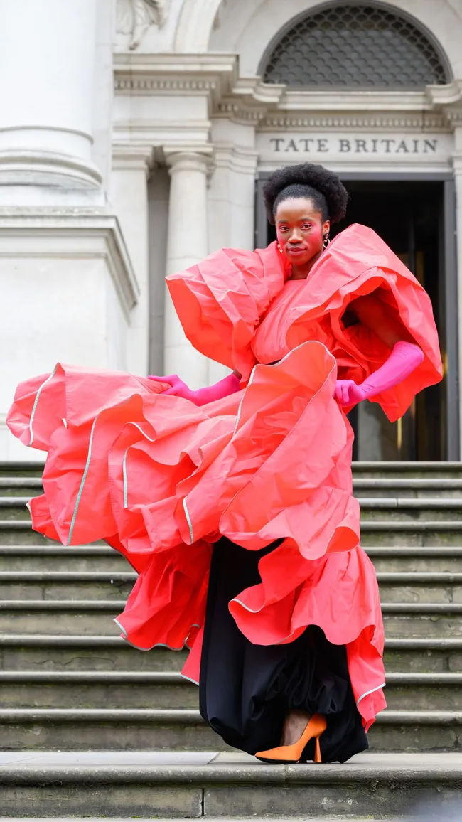 Yos Clark wears a Roksanda dress and gloves and Zara shoes during London Fashion Week February 2024 at the Roksanda show on February 17, 2024 in London, England.