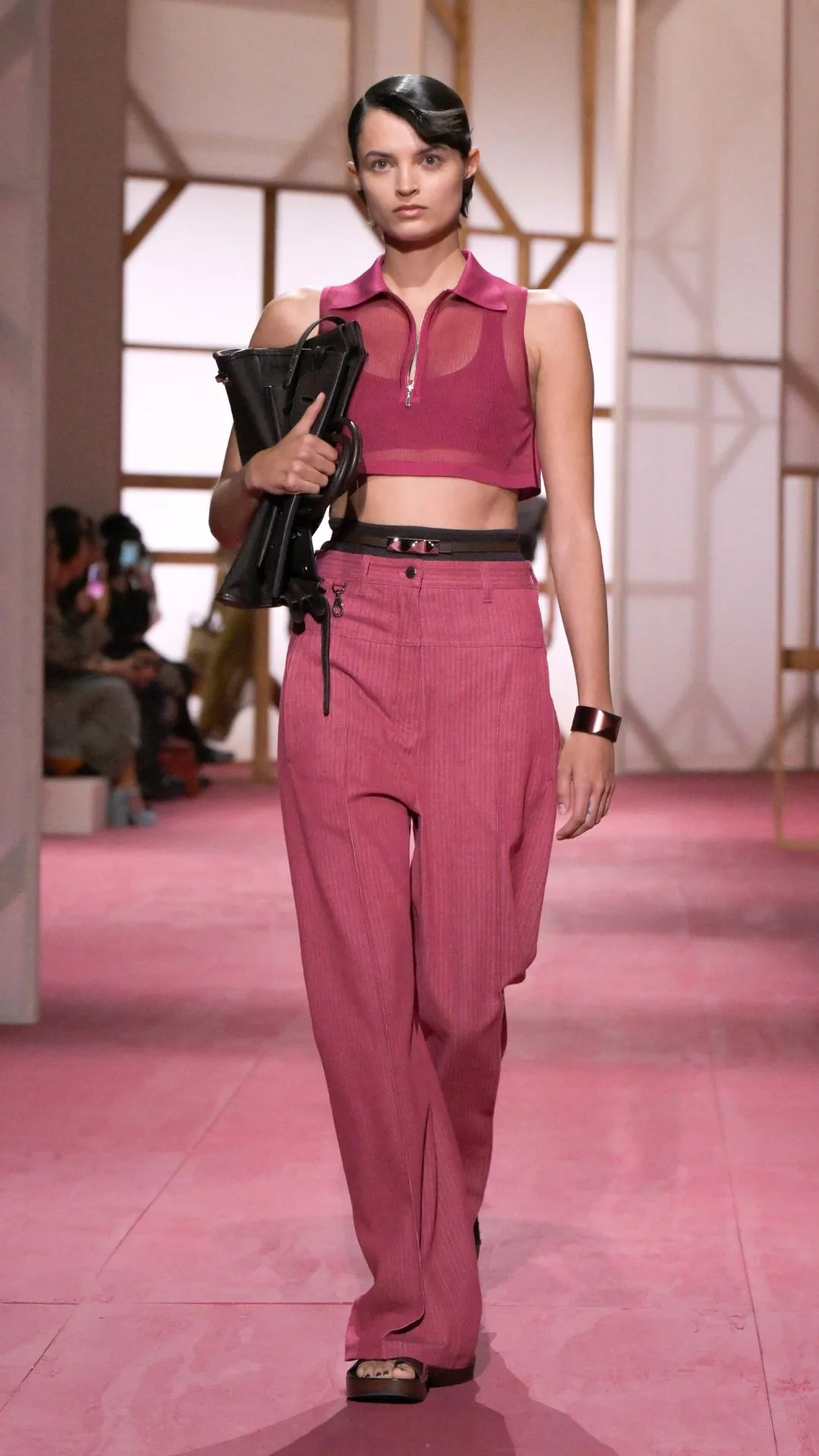 model wears pink jeans and crop top on the runway at Hermes SS25