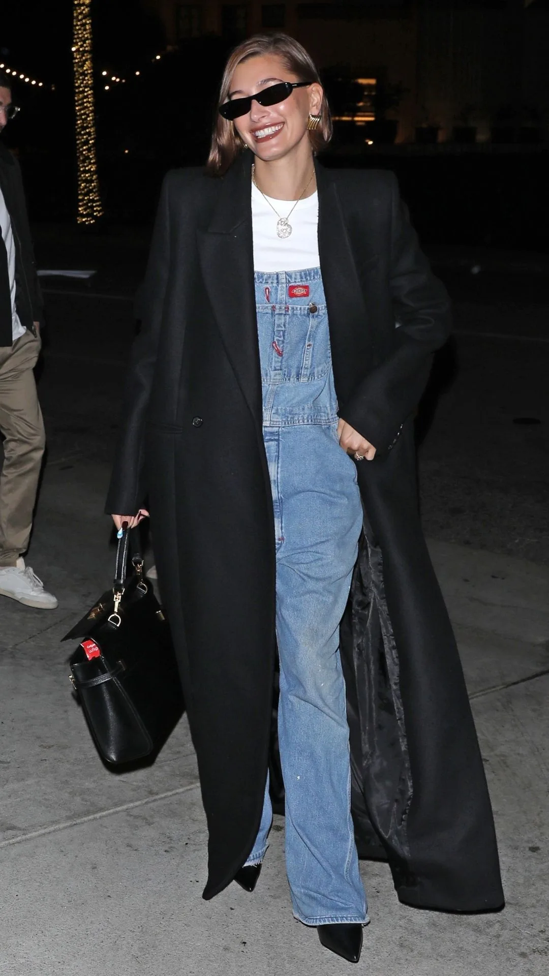 Hailey Bieber in Dickies and a chic trench and heels 