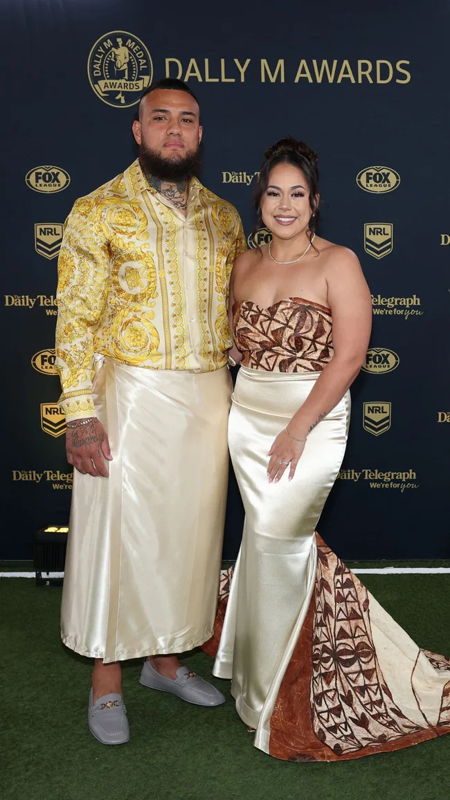 Addin Fonua-Blake of the Warriors and Ana Fonua-Blake wearing traditional golden and silk jacket and skirt on red carpet