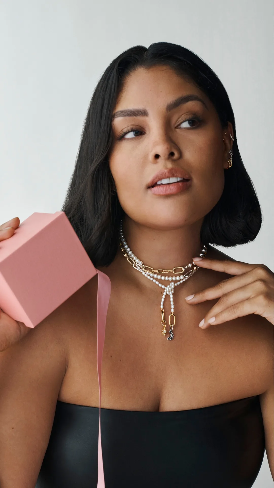 Woman holding a gift box with Pandora jewellery