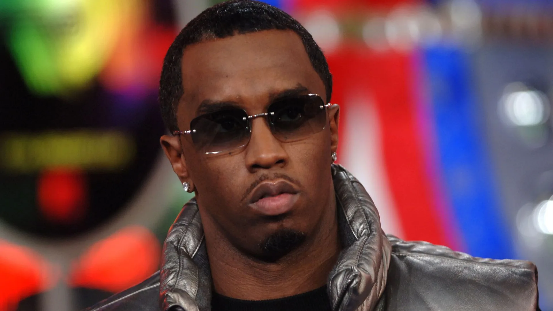 sean diddy combs wears sunglesses and leather vest 