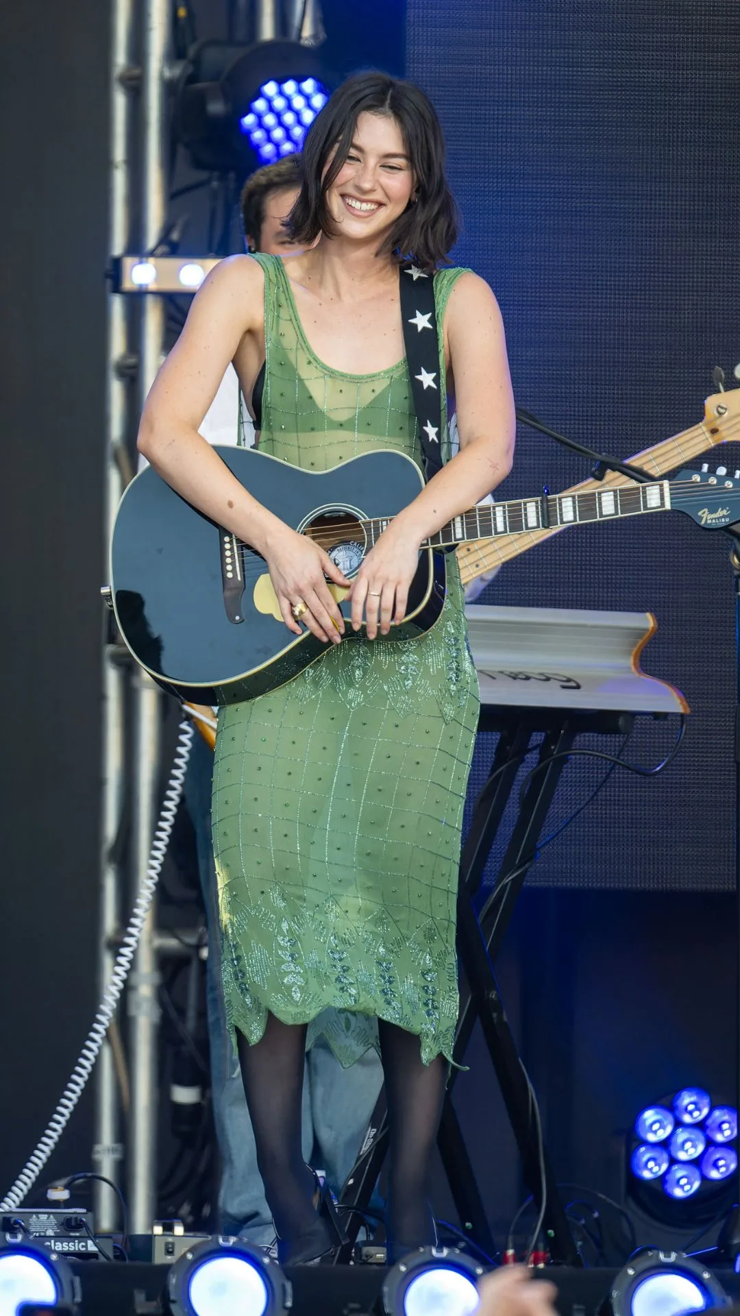 Gracie abrams performs on stage in sheer green dress