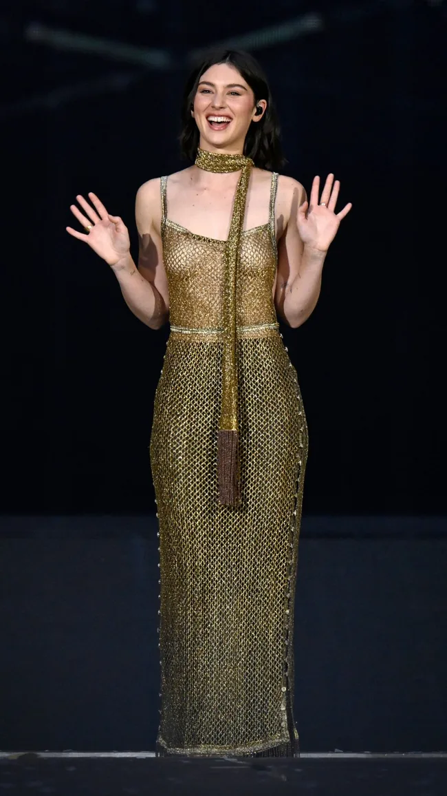 gracie abrams wears gold dress to perform at Eras tour