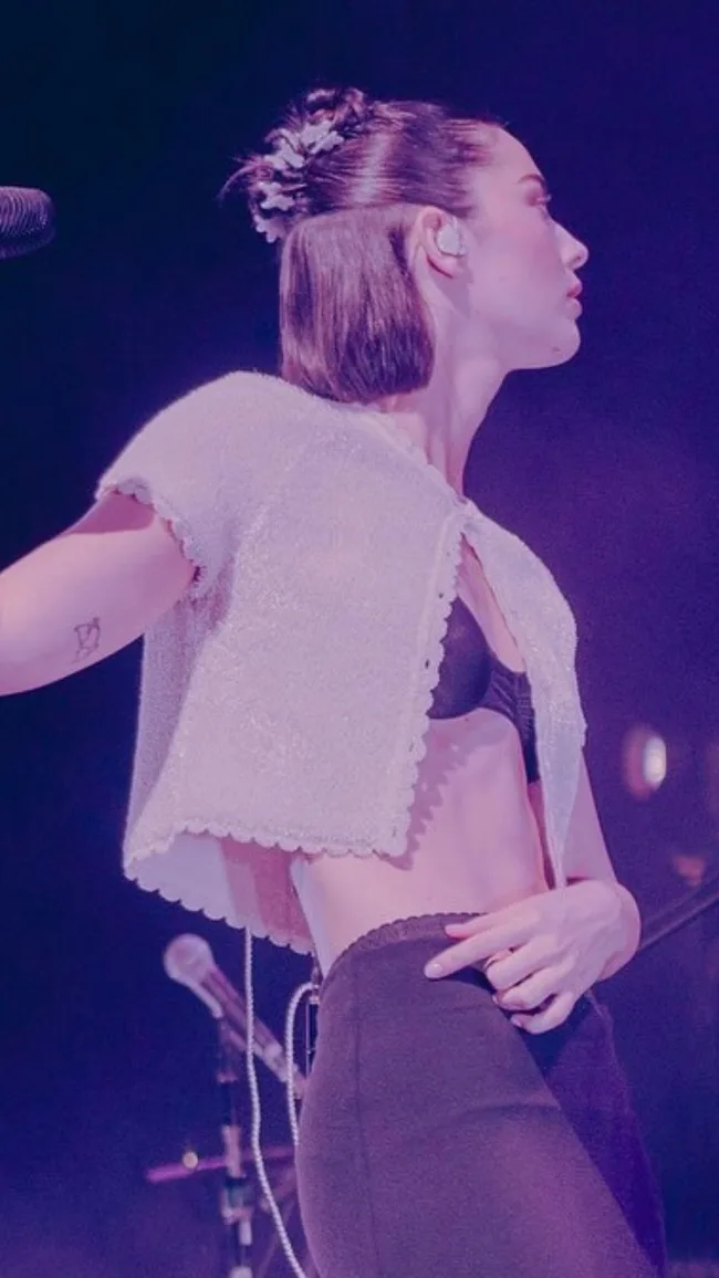 gracie abrams on tour in open crop top showing bra