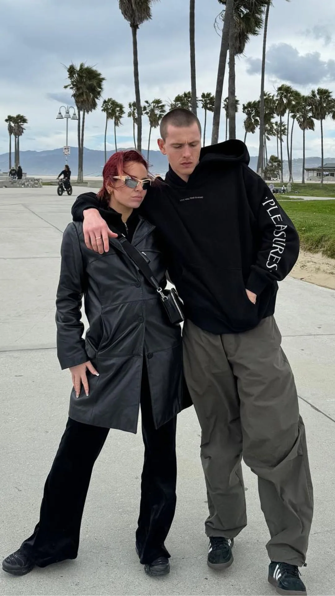 Harris dickinson and his girlfriend rose gray pose on Venice Beach in LA wearing black