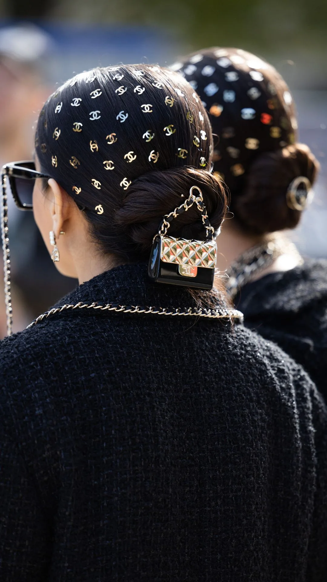 Twins Jyoti Babani, Snehal Babani wearing logo hair clips, micro bag outside Chanel during Womenswear Spring/Summer 2025 as part of Paris Fashion Week on October 01, 2024 in Paris, France.