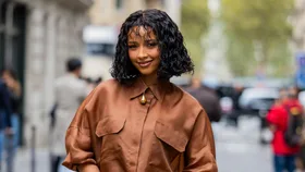 Flora Coquerel wears brown blouse, skirt, black bag outside Akris during Womenswear Spring/Summer 2025 as part of Paris Fashion Week on September 29, 2024 in Paris, France.