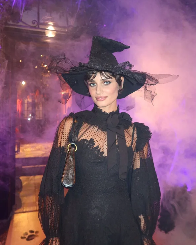 taylor hill dressed as a witch for halloween 2024