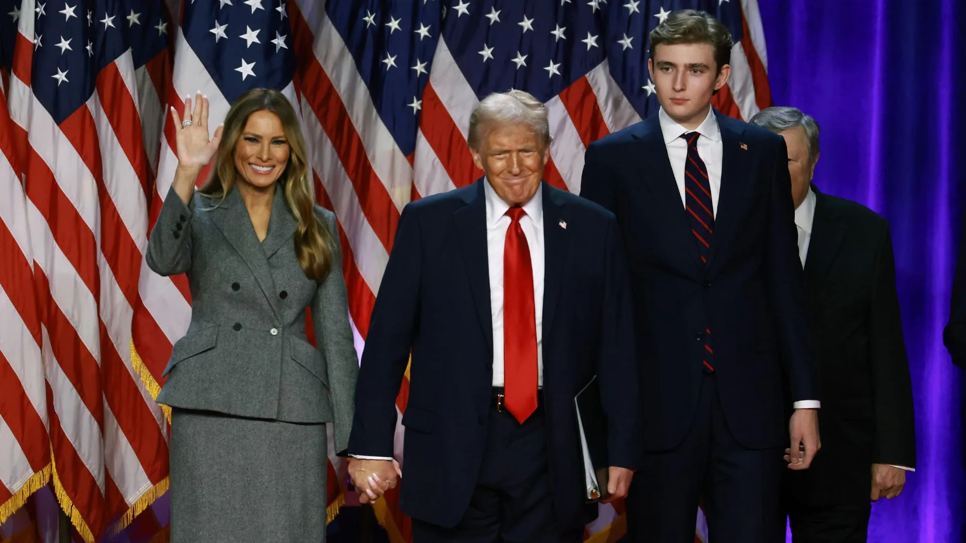 Republican presidential nominee, former U.S. President Donald Trump dances on stage with former first lady Melania Trump and Barron Trump during an election night event at the Palm Beach Convention Center on November 06, 2024 in West Palm Beach, Florida. Americans cast their ballots today in the presidential race between Republican nominee former President Donald Trump and Vice President Kamala Harris, as well as multiple state elections that will determine the balance of power in Congress. 