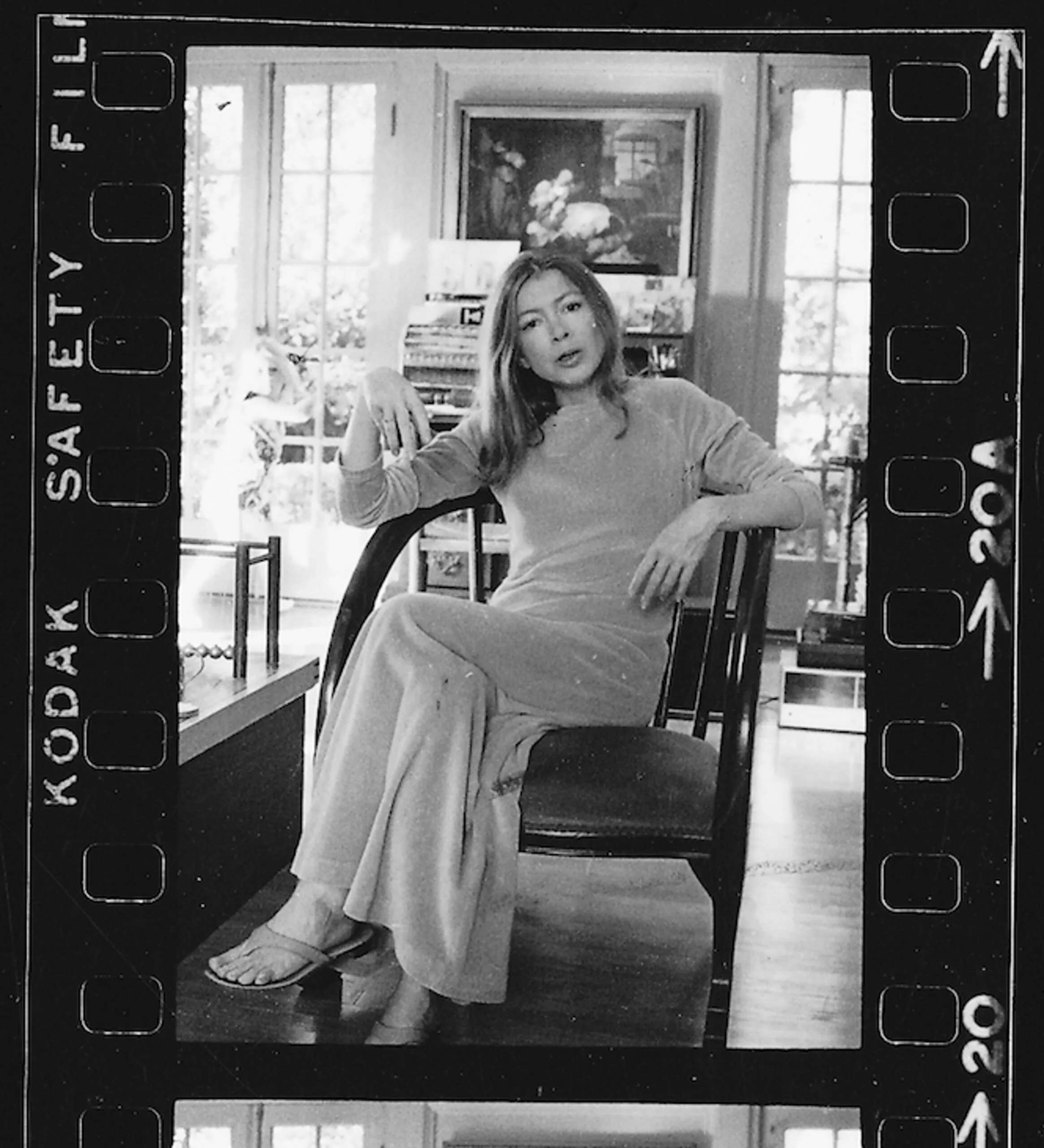 joan didion black and white photograph in chair