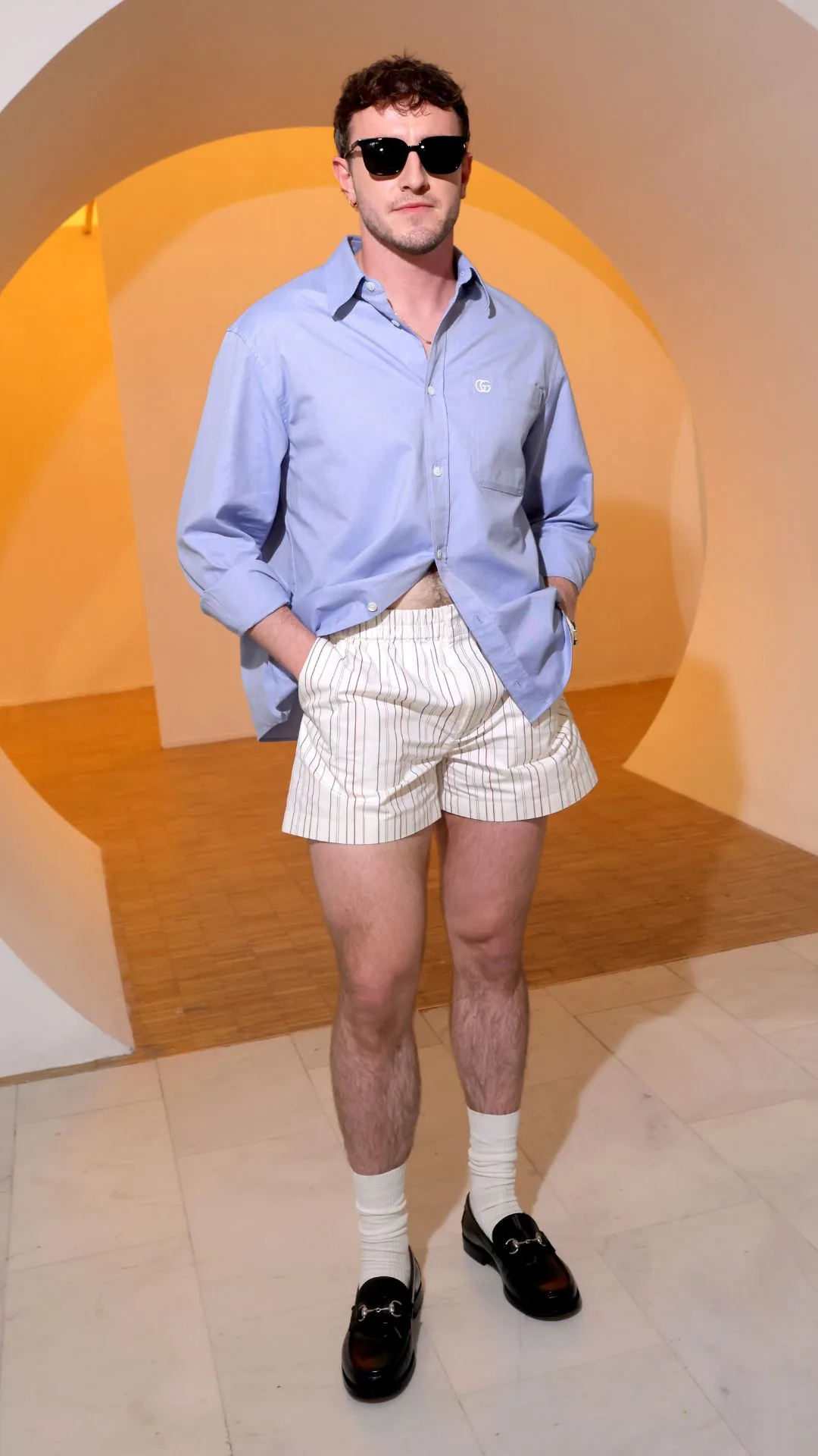 Paul Mescal at Gucci Men's Spring Summer 2025 show wearing pyjama like shorts and loafers