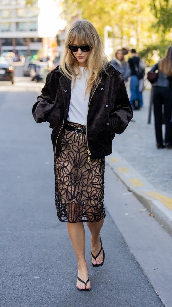 Jeanette Friis Madsen wears brown suede oversized zipper jacket, transparent black skirt, white shirt outside Christopher Esber during the Womenswear Spring Summer 2026 as part of Paris Fashion Week on October 07, 2025 in Paris, France.