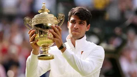 Carlos Alcaraz of Spain poses with the Gentlemen's Singles Trophy following victory against Novak Djokovic of Serbia in the Gentlemen's Singles Final during day fourteen of The Championships Wimbledon 2024 at All England Lawn Tennis and Croquet Club on July 14, 2024 in London, England.