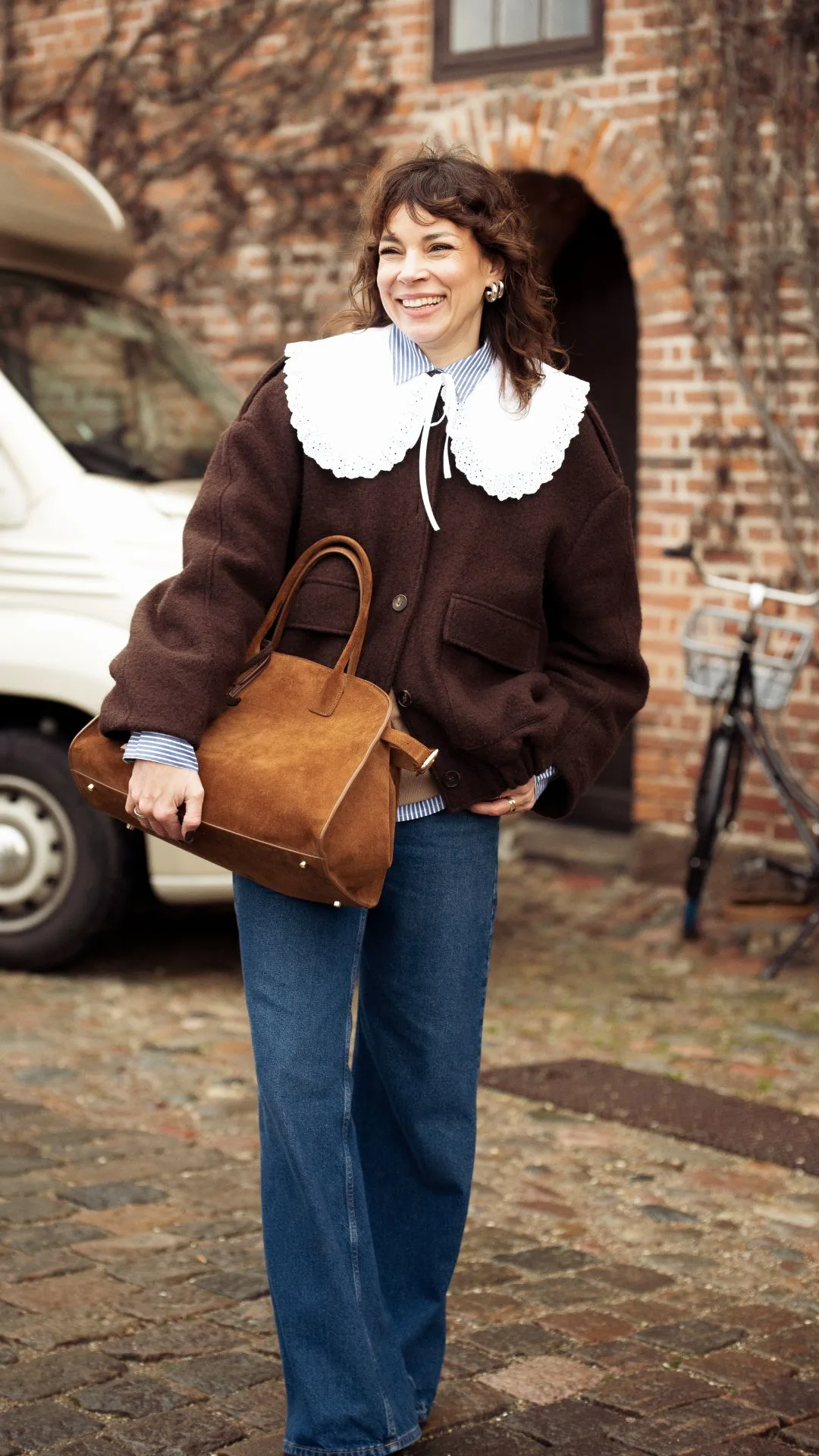 copenhagen street style fashion week autumn winter 2025 woman wears brown jacket with white peter pan collar